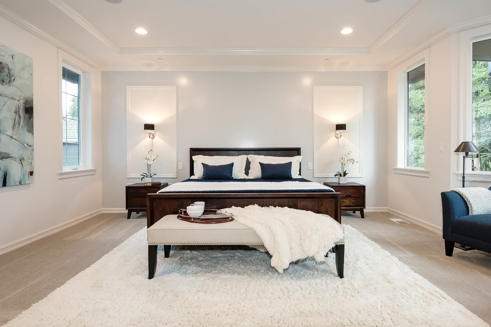 This is an example of a large transitional master bedroom in Seattle with white walls, carpet and no fireplace.
