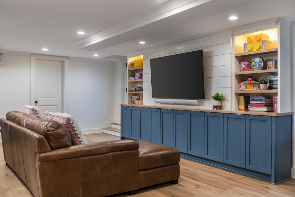 This is an example of a large traditional walk-out basement in Atlanta with a home bar, white walls, vinyl flooring, beige floors and wallpapered walls.