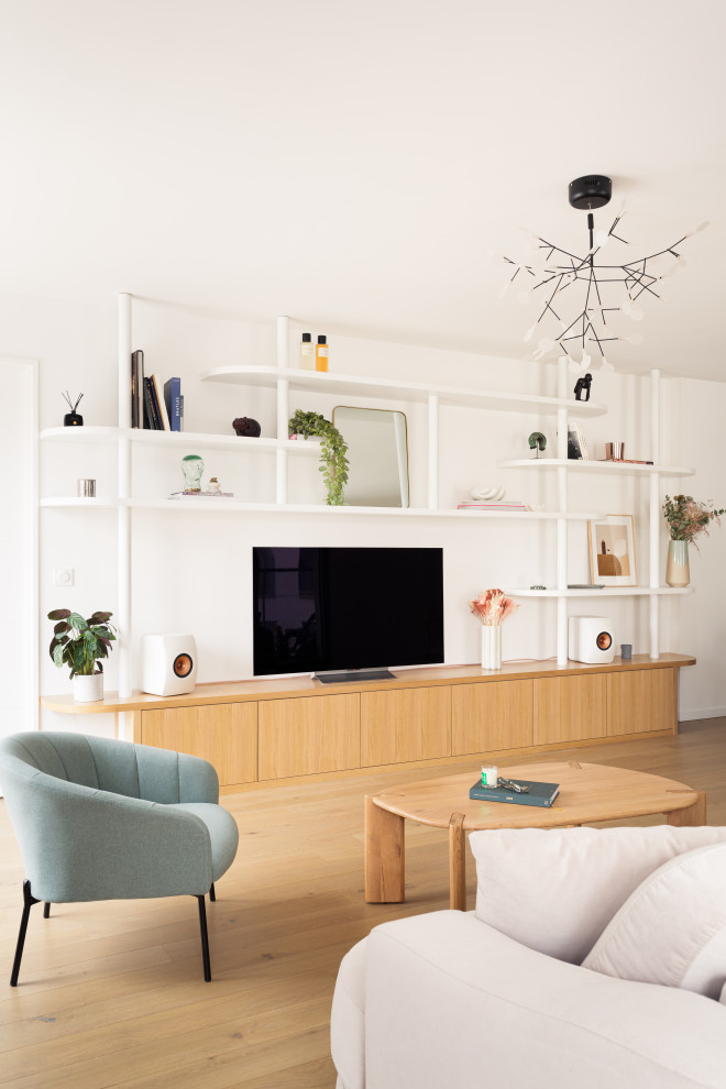 Photo of a medium sized scandi open plan living room in Paris with a reading nook, white walls, light hardwood flooring, no fireplace and a freestanding tv.