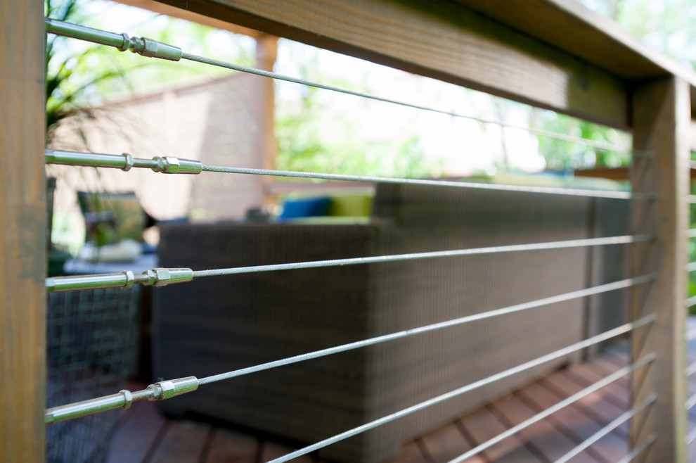 This is an example of a mid-sized contemporary backyard deck in DC Metro with a pergola.