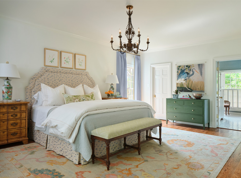 На фото: хозяйская спальня в классическом стиле с белыми стенами и паркетным полом среднего тона с