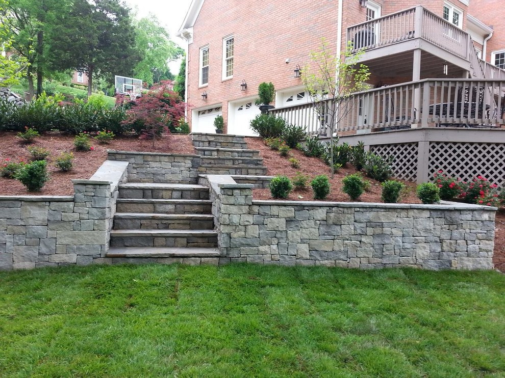 This is an example of a mid-sized traditional backyard full sun garden in Nashville with natural stone pavers.