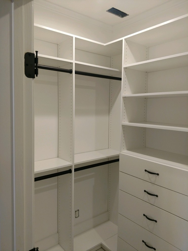 This is an example of a small transitional gender-neutral walk-in wardrobe in Louisville with open cabinets and white cabinets.