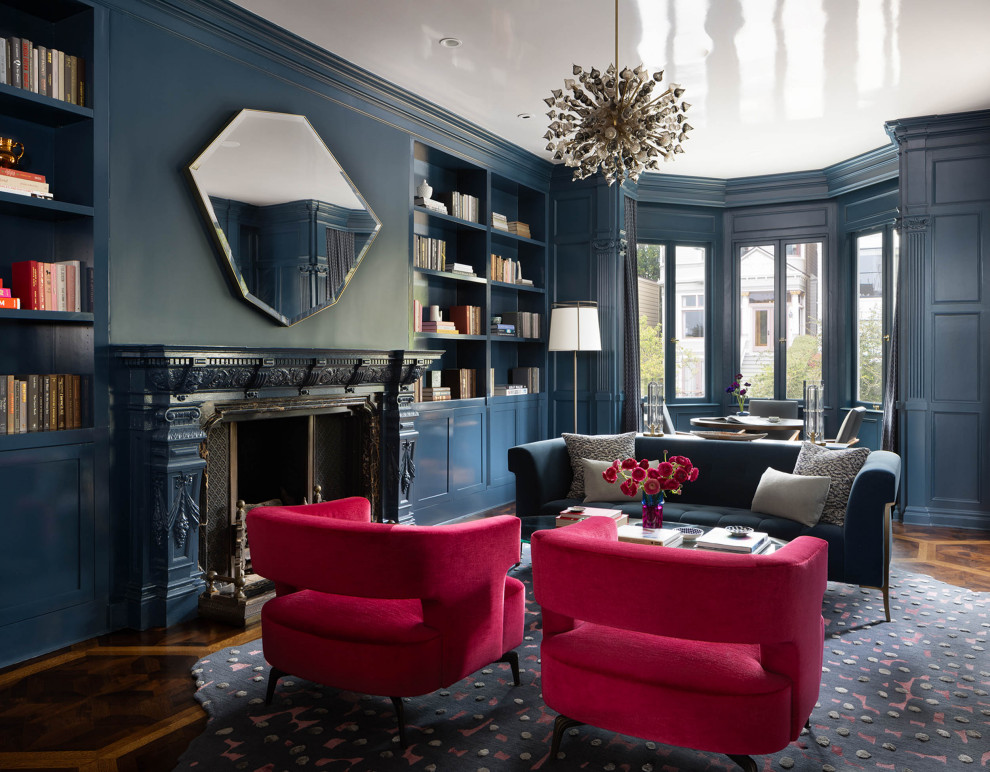 Aménagement d'un très grand salon classique fermé avec une salle de réception, un mur bleu, un sol en bois brun, une cheminée standard, un sol multicolore et du lambris.