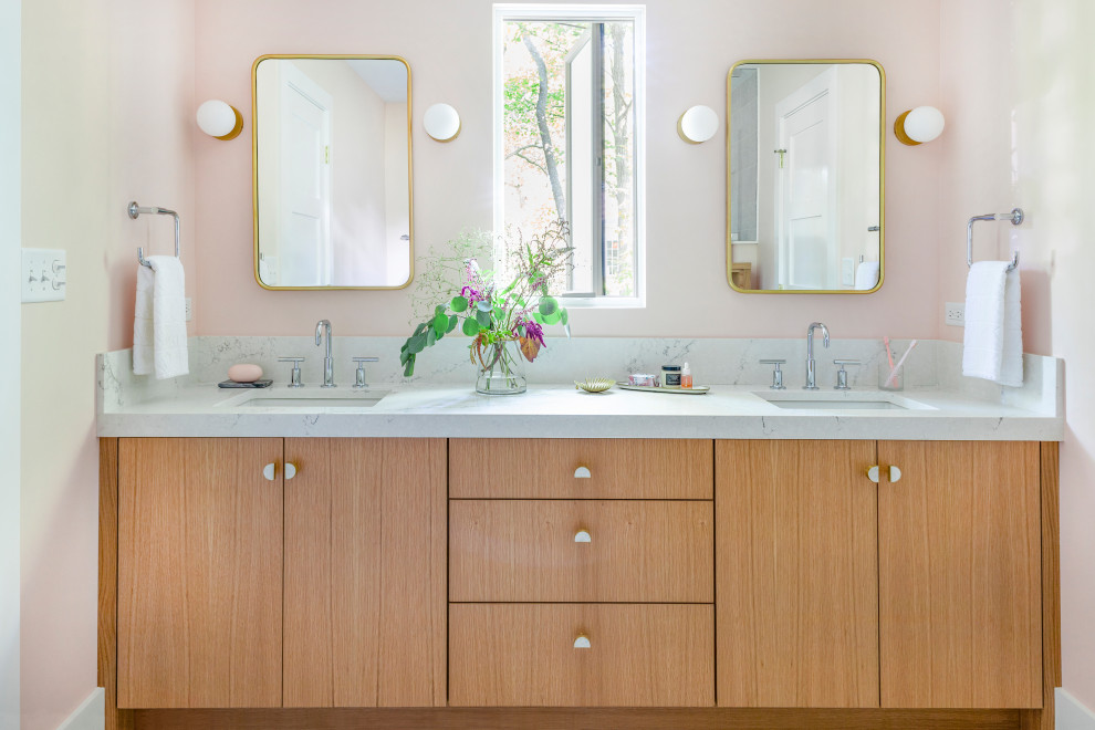 Photo of a mid-sized contemporary kids bathroom in Chicago with flat-panel cabinets, light wood cabinets, a corner shower, a two-piece toilet, white tile, mosaic tile, pink walls, an undermount sink, engineered quartz benchtops, grey floor, a hinged shower door and white benchtops.
