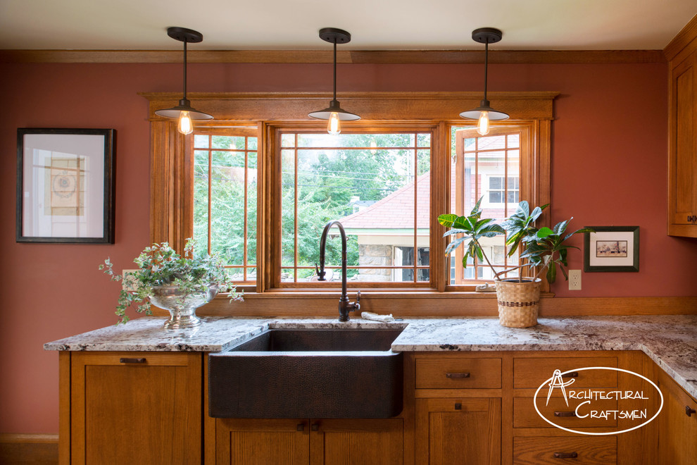 Design ideas for a country kitchen in Kansas City with a farmhouse sink, shaker cabinets, medium wood cabinets, granite benchtops and panelled appliances.