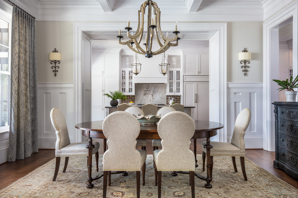 Traditional separate dining room in Charleston with beige walls, dark hardwood floors and brown floor.
