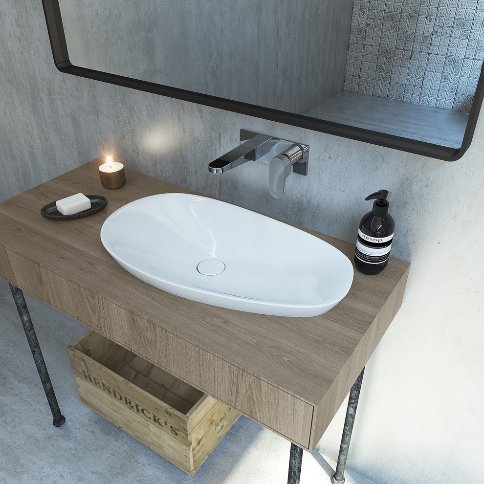 Photo of an expansive industrial master bathroom in Sydney with a vessel sink, wood benchtops, a freestanding tub, an open shower, a wall-mount toilet and concrete floors.