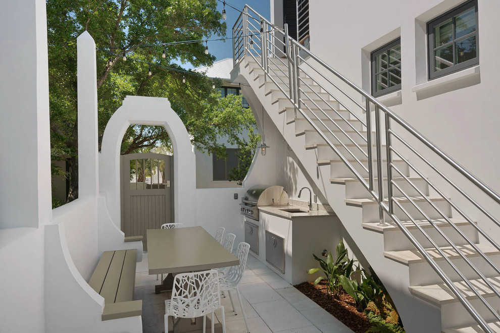 Photo of a small transitional courtyard patio in Miami with an outdoor kitchen, concrete pavers and no cover.