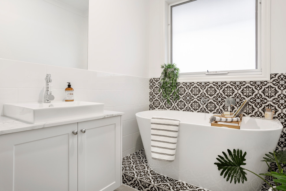 Transitional 3/4 bathroom in Melbourne with shaker cabinets, white cabinets, a freestanding tub, black and white tile, gray tile, white walls, a vessel sink, marble benchtops, multi-coloured floor, multi-coloured benchtops, a single vanity, a built-in vanity and ceramic tile.