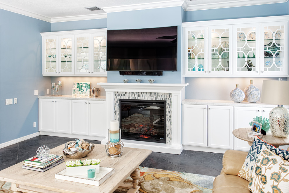Design ideas for a large beach style open concept family room in Miami with blue walls, slate floors, a standard fireplace, a tile fireplace surround, a wall-mounted tv and a game room.