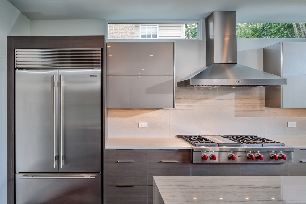 This is an example of a mid-sized contemporary u-shaped open plan kitchen in Chicago with an undermount sink, flat-panel cabinets, grey cabinets, quartzite benchtops, white splashback, stone slab splashback, stainless steel appliances, dark hardwood floors, with island and brown floor.