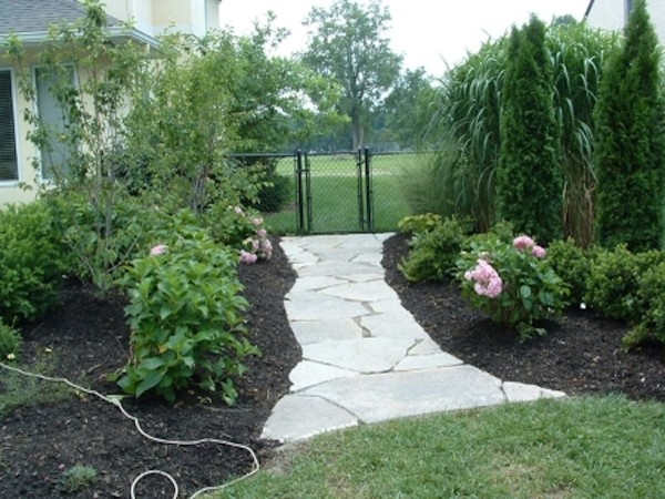 Mid-sized traditional backyard partial sun formal garden in Columbus with a garden path and natural stone pavers for spring.