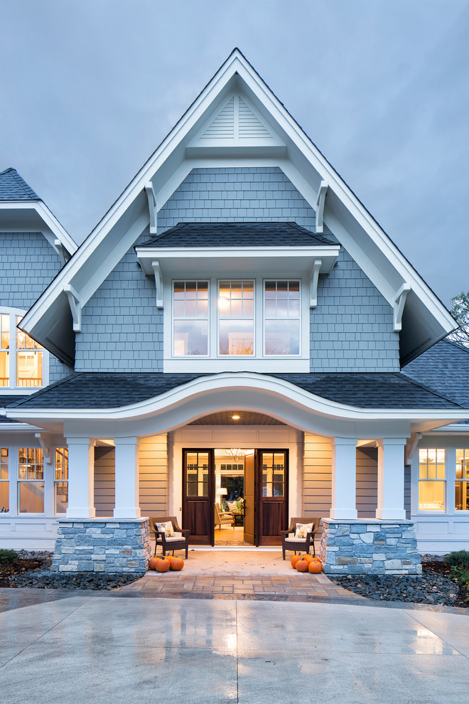 Inspiration for an expansive traditional two-storey grey exterior in Minneapolis with wood siding and a clipped gable roof.