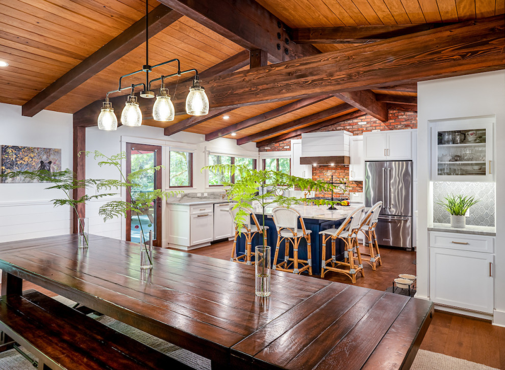 Kitchen - mid-sized rustic l-shaped vinyl floor, brown floor and exposed beam kitchen idea with an undermount sink, recessed-panel cabinets, white cabinets, quartzite countertops, brown backsplash, brick backsplash, stainless steel appliances, an island and white countertops