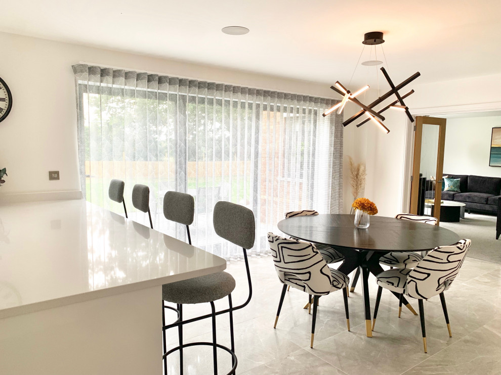 Photo of a large contemporary kitchen/dining combo in Hertfordshire with white walls, porcelain floors and grey floor.