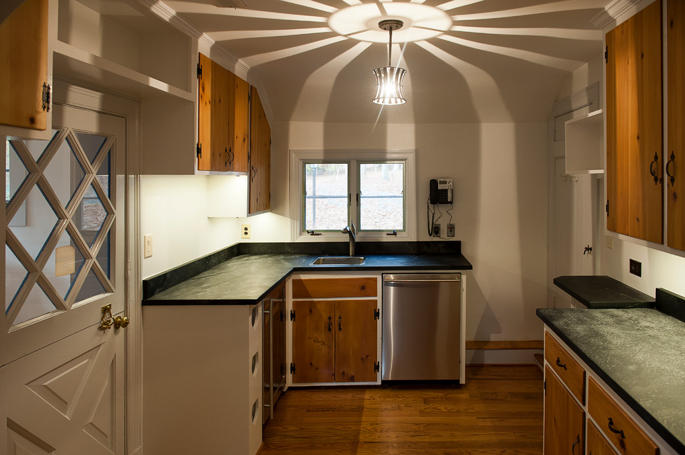 Kitchen pantry - large rustic medium tone wood floor kitchen pantry idea with no island, an undermount sink, soapstone countertops and stainless steel appliances