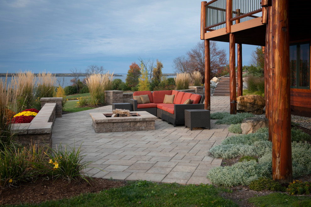 Photo of an expansive rural back full sun garden in Burlington with a fire feature and concrete paving.