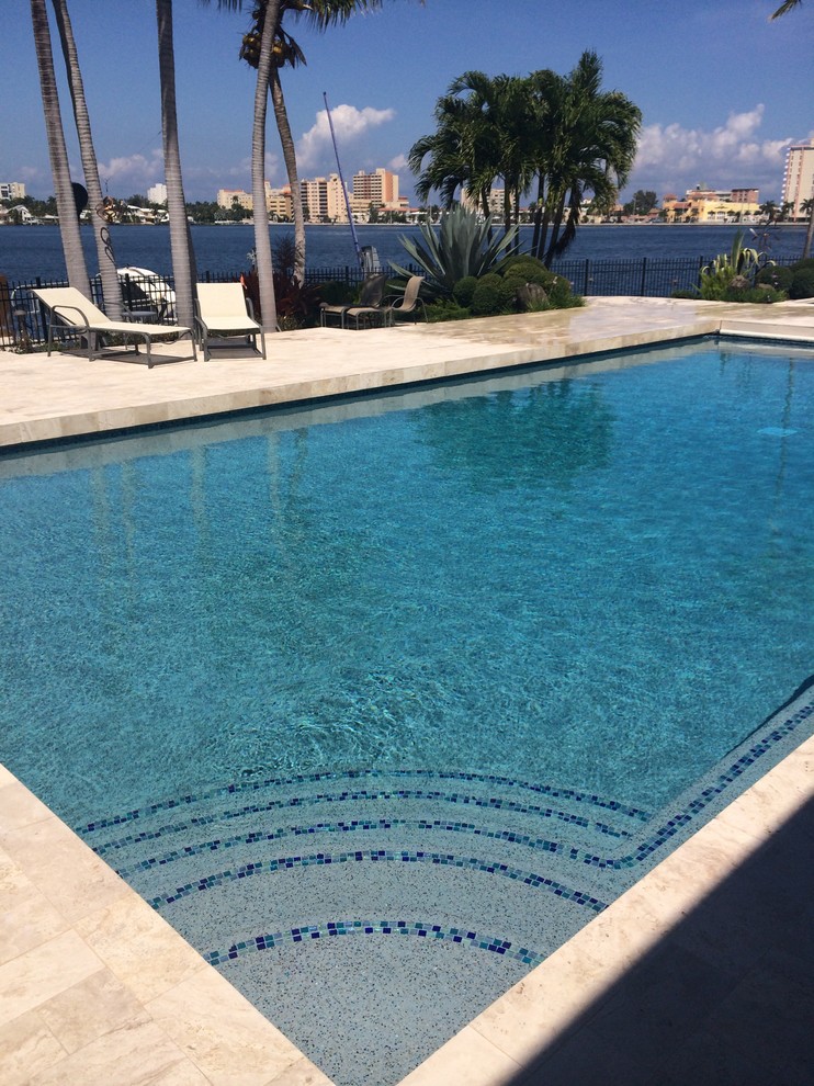 Inspiration for a large transitional backyard rectangular and tile lap pool remodel in Miami