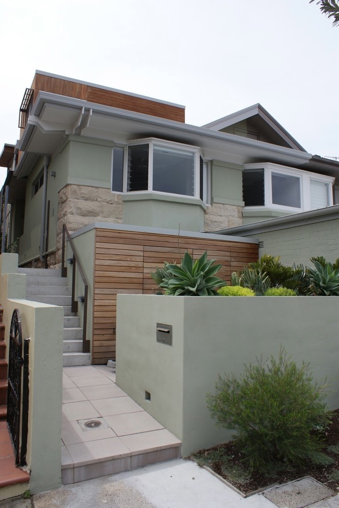 Mid-sized contemporary two-storey green exterior in Sydney with wood siding.