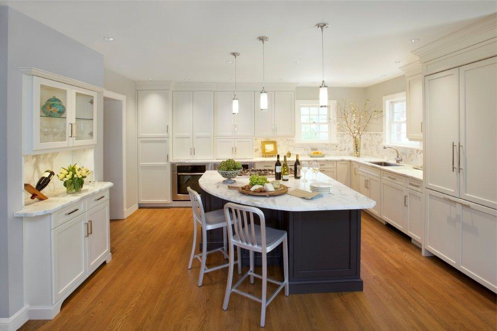 Photo of a large transitional l-shaped eat-in kitchen in DC Metro with a farmhouse sink, flat-panel cabinets, white cabinets, marble benchtops, multi-coloured splashback, stone slab splashback, stainless steel appliances, medium hardwood floors and with island.