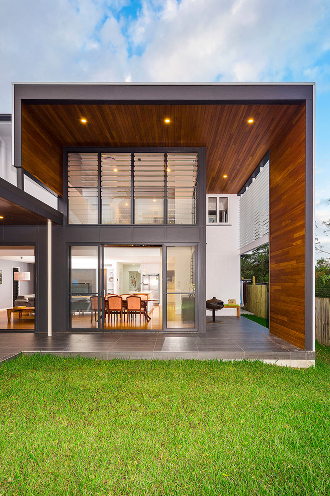 Large modern house exterior in Brisbane with wood siding and a tile roof.