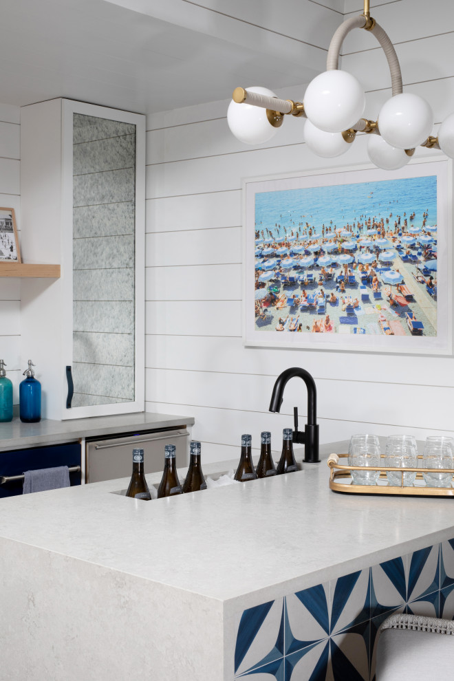 Inspiration for a huge coastal galley vinyl floor and brown floor seated home bar remodel in New York with an undermount sink, flat-panel cabinets, white cabinets, quartz countertops, blue backsplash, stone tile backsplash and gray countertops