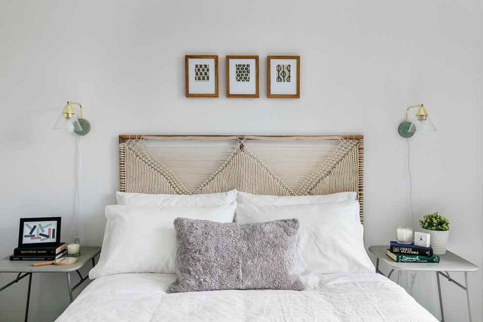 This is an example of an eclectic bedroom in New York with white walls.