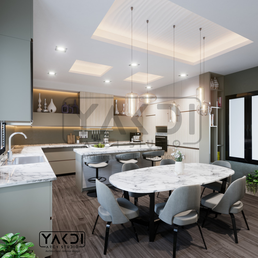 Large minimalist u-shaped porcelain tile, brown floor and coffered ceiling eat-in kitchen photo with a double-bowl sink, beaded inset cabinets, light wood cabinets, marble countertops, green backsplash, stone slab backsplash, stainless steel appliances, an island and white countertops