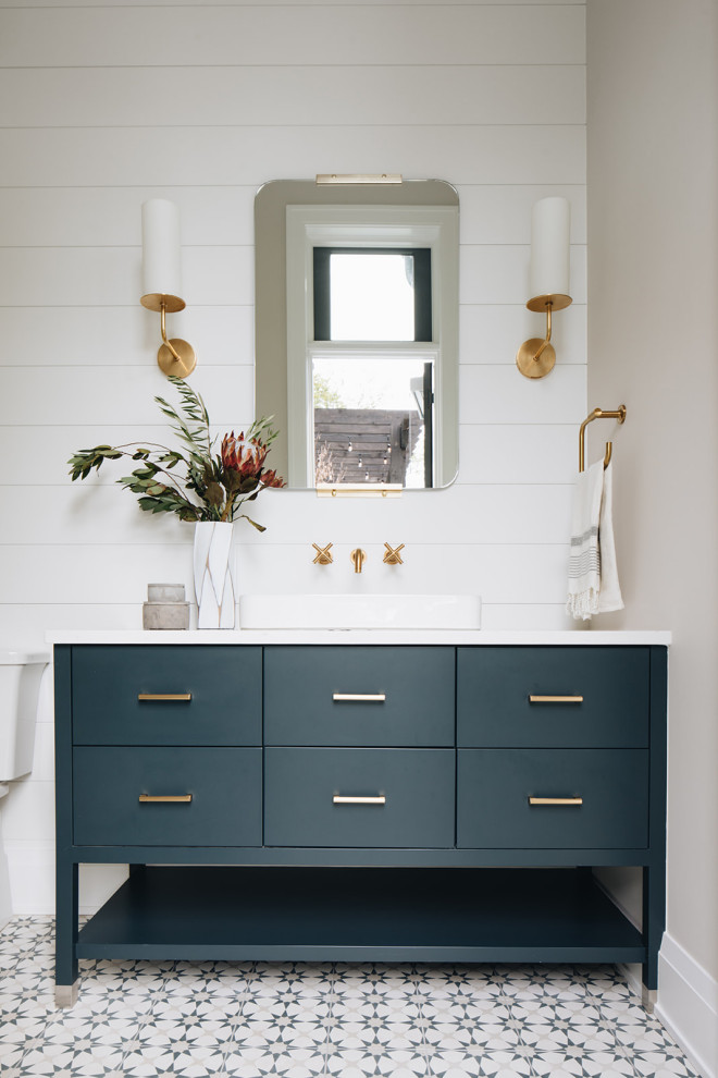 Inspiration for a mid-sized transitional bathroom in Chicago with flat-panel cabinets, blue cabinets, a two-piece toilet, white walls, cement tiles, a vessel sink, engineered quartz benchtops, white floor and white benchtops.