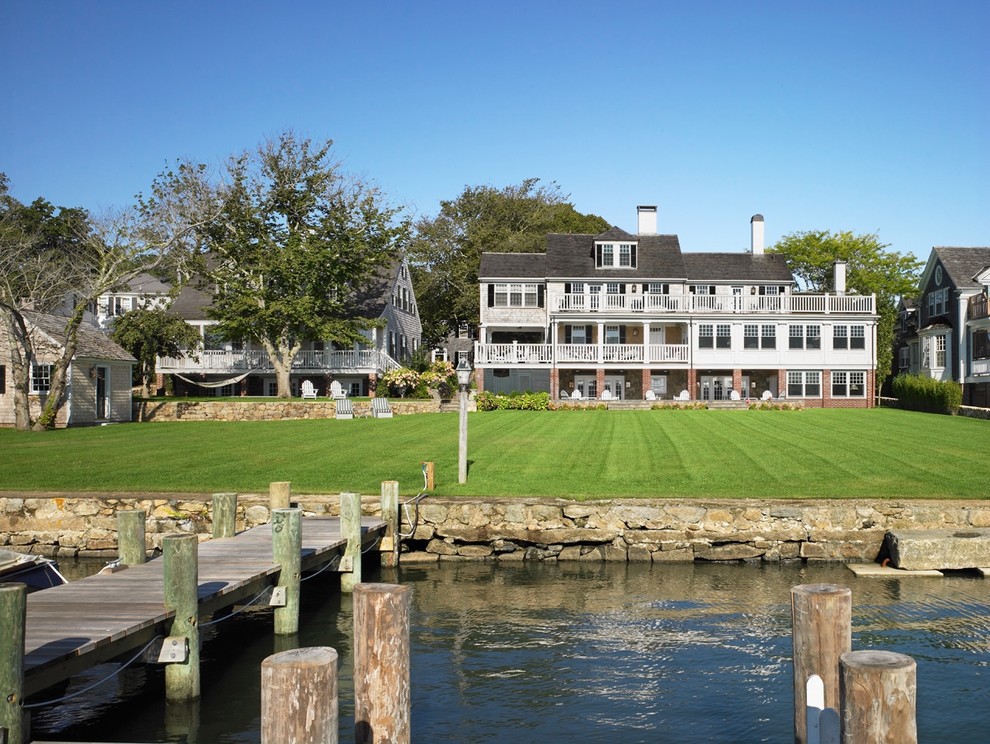 Photo of a large beach style three-storey exterior in Boston with wood siding.