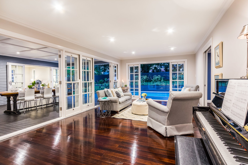 Photo of a large traditional open concept family room in Brisbane with grey walls and medium hardwood floors.