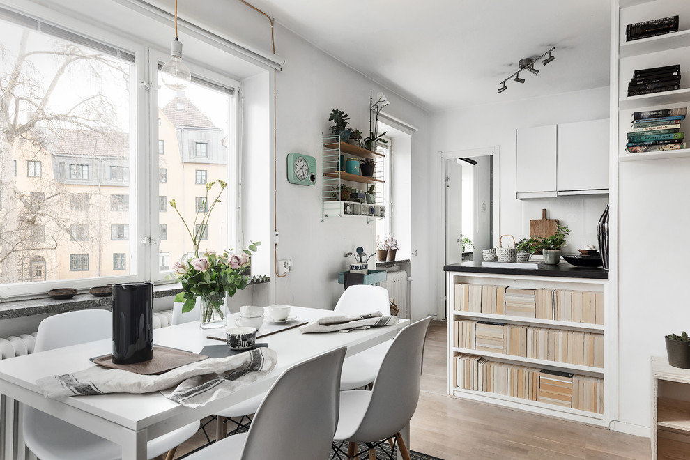 Mid-sized scandinavian dining room in Stockholm with white walls.