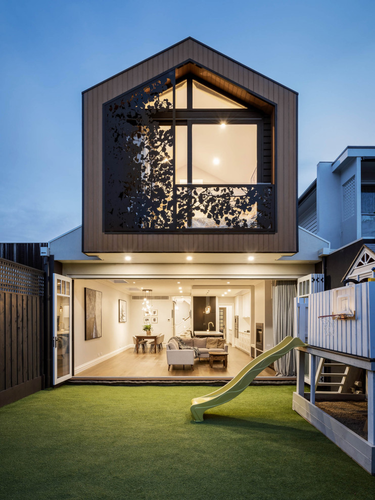 This is an example of a contemporary two-storey grey house exterior in Melbourne with a gable roof.