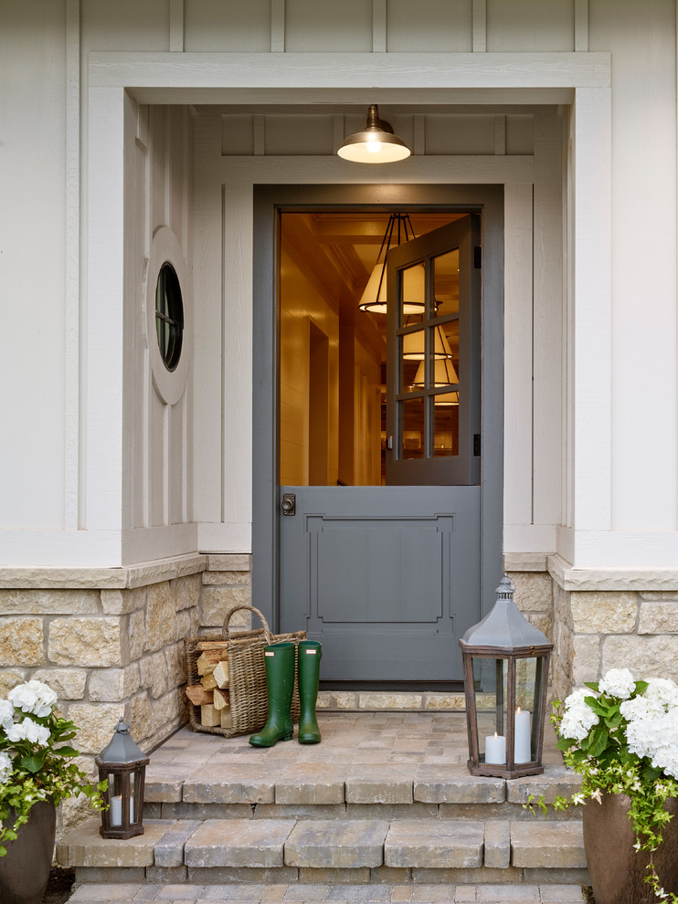 Photo of a country entryway in Salt Lake City with a dutch front door and a gray front door.