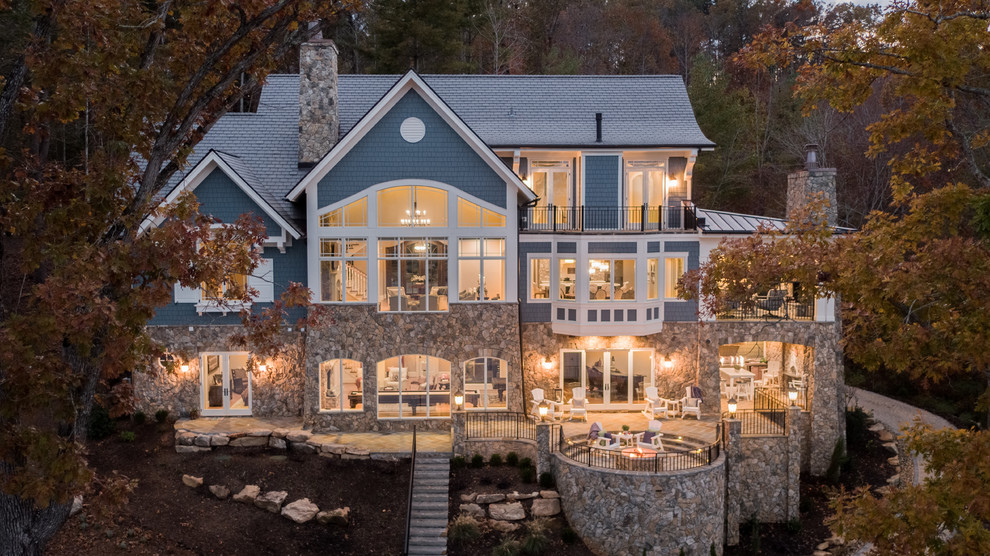 Large traditional blue two-story mixed siding exterior home idea in Other with a shingle roof