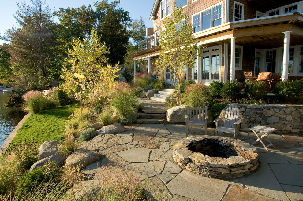 Design ideas for a large beach style side yard full sun garden in Boston with a fire feature and natural stone pavers.