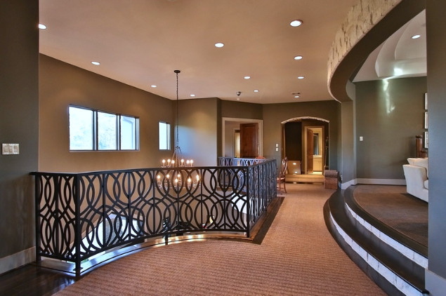 Inspiration for an expansive transitional hallway in Houston with brown walls and dark hardwood floors.