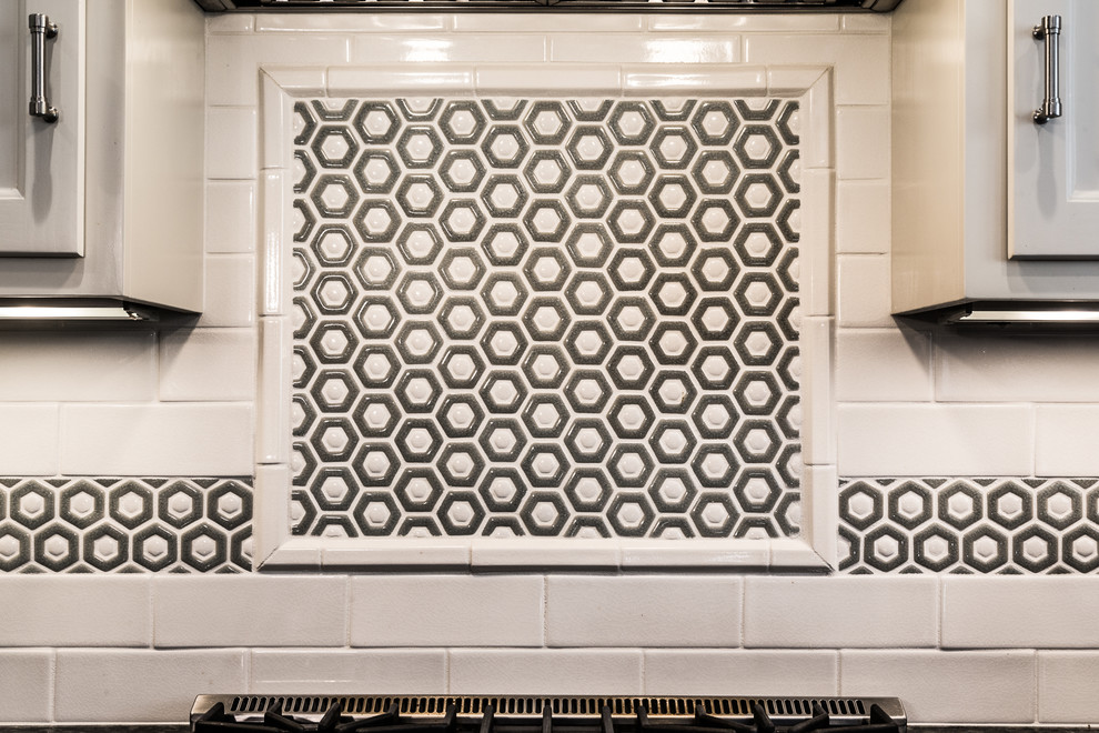 Large transitional u-shaped brown floor and dark wood floor eat-in kitchen photo in Chicago with an undermount sink, raised-panel cabinets, white cabinets, granite countertops, white backsplash, stainless steel appliances, an island and subway tile backsplash