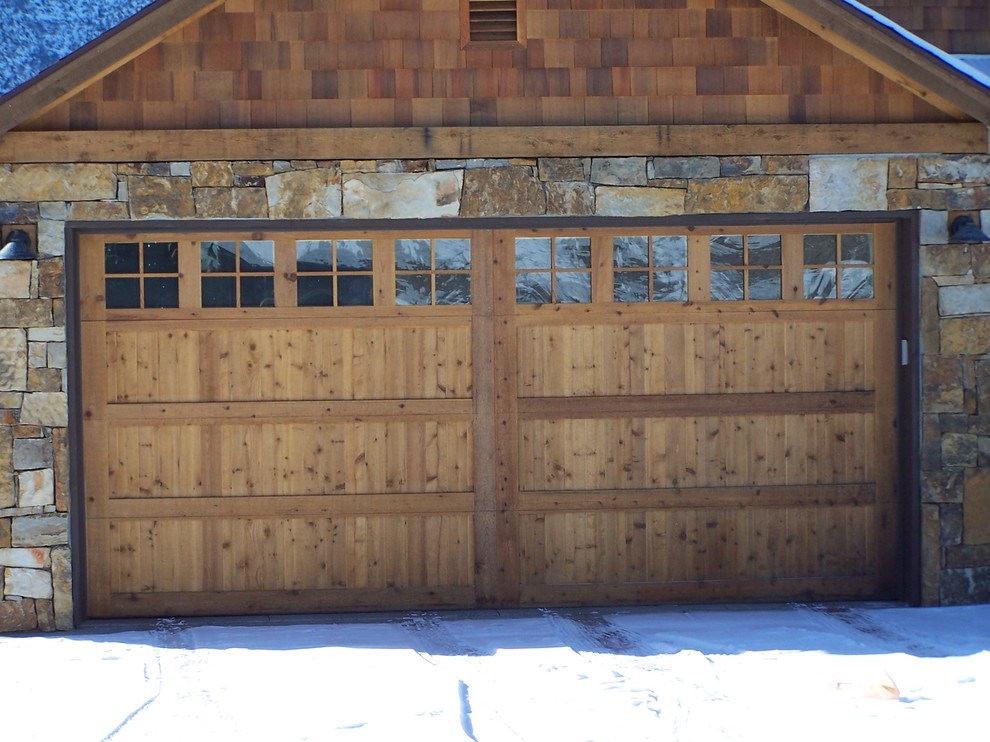 This is an example of a mid-sized arts and crafts attached two-car garage in Denver.