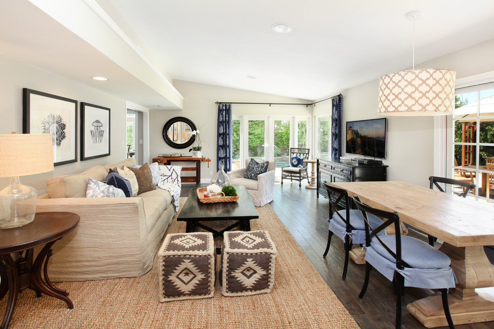 Beach style living room in Orange County with beige walls and a wall-mounted tv.