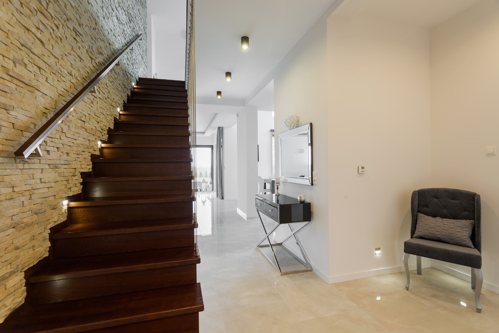 Design ideas for a contemporary entry hall in Melbourne with white walls, porcelain floors and beige floor.