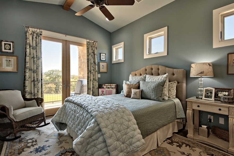 Photo of a mid-sized traditional master bedroom in Austin with blue walls and dark hardwood floors.