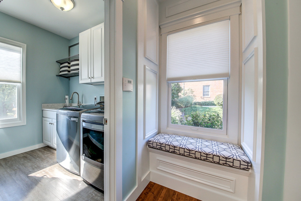 Photo of a mid-sized beach style single-wall dedicated laundry room in Dallas with an undermount sink, raised-panel cabinets, white cabinets, granite benchtops, blue walls, vinyl floors, a side-by-side washer and dryer, grey floor and grey benchtop.