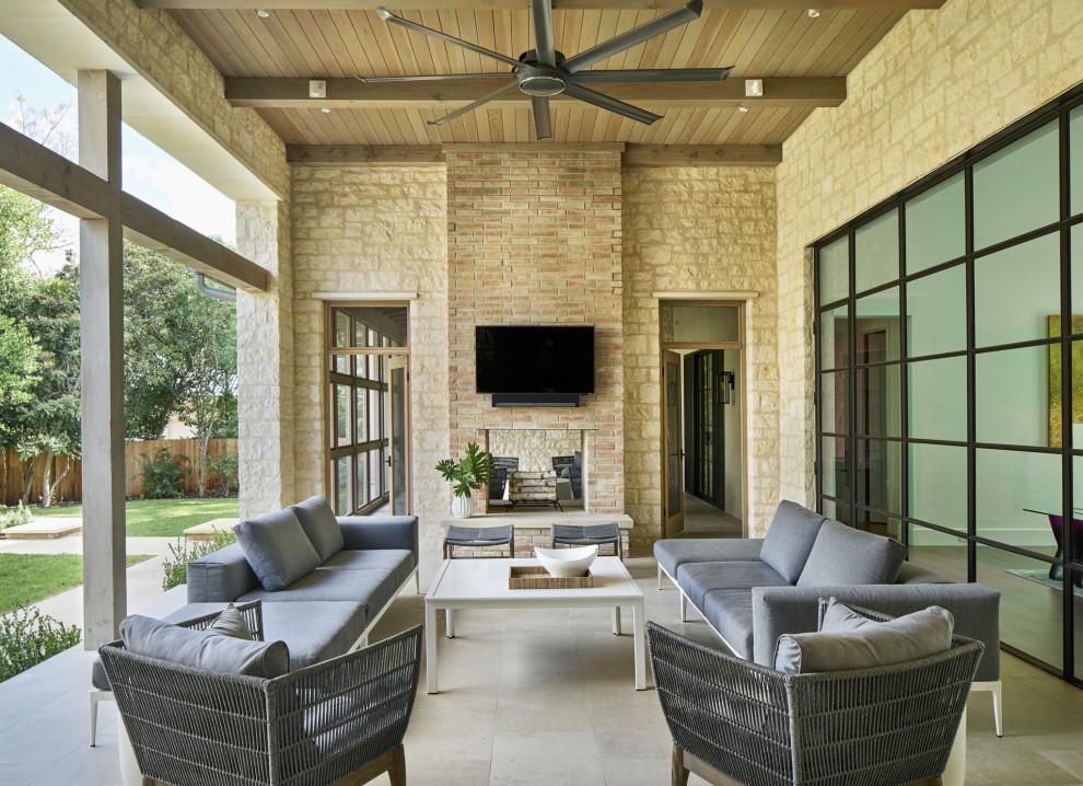 Transitional patio in Austin with with fireplace and a roof extension.