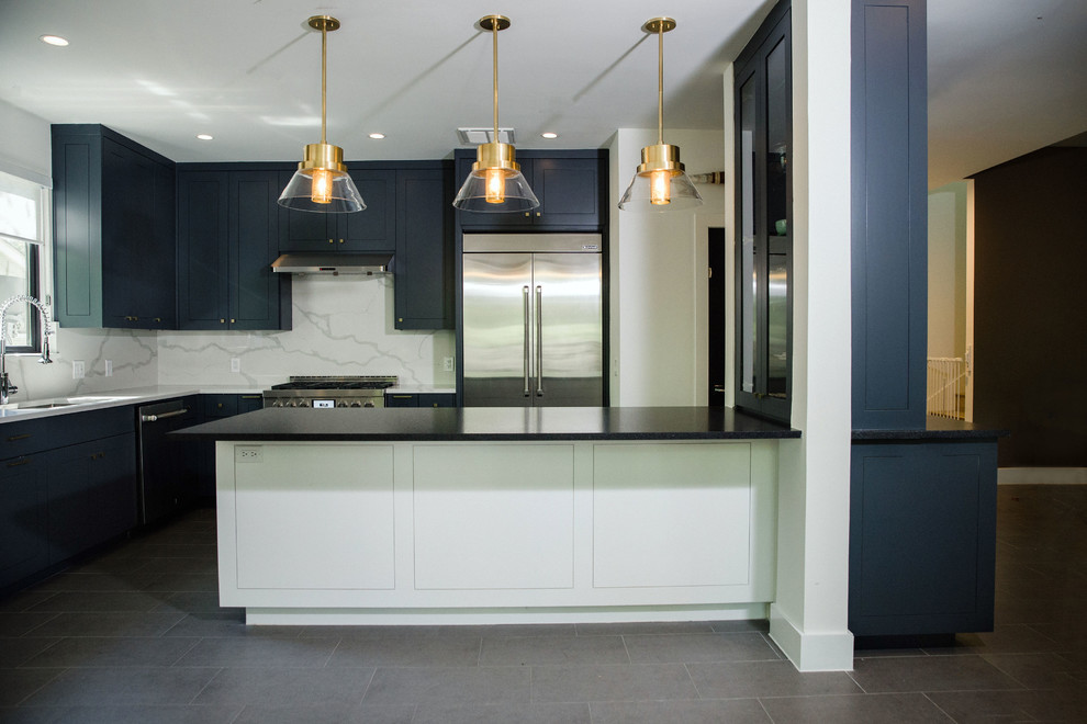Inspiration for a mid-sized transitional l-shaped cement tile floor and gray floor eat-in kitchen remodel in Austin with an undermount sink, flat-panel cabinets, blue cabinets, quartz countertops, white backsplash, stainless steel appliances, an island and white countertops
