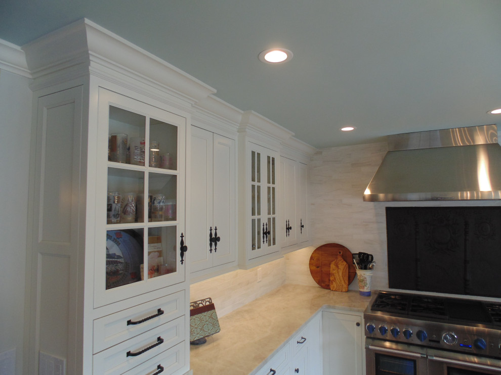 Inspiration for a large transitional u-shaped medium tone wood floor and brown floor eat-in kitchen remodel with an undermount sink, recessed-panel cabinets, white cabinets, quartzite countertops, beige backsplash, subway tile backsplash, stainless steel appliances, an island and beige countertops
