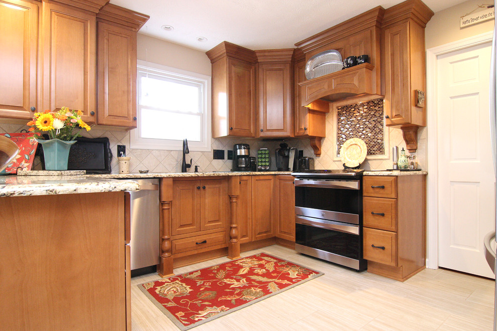 Example of a large transitional u-shaped porcelain tile eat-in kitchen design with an undermount sink, raised-panel cabinets, medium tone wood cabinets, granite countertops, beige backsplash, porcelain backsplash and stainless steel appliances
