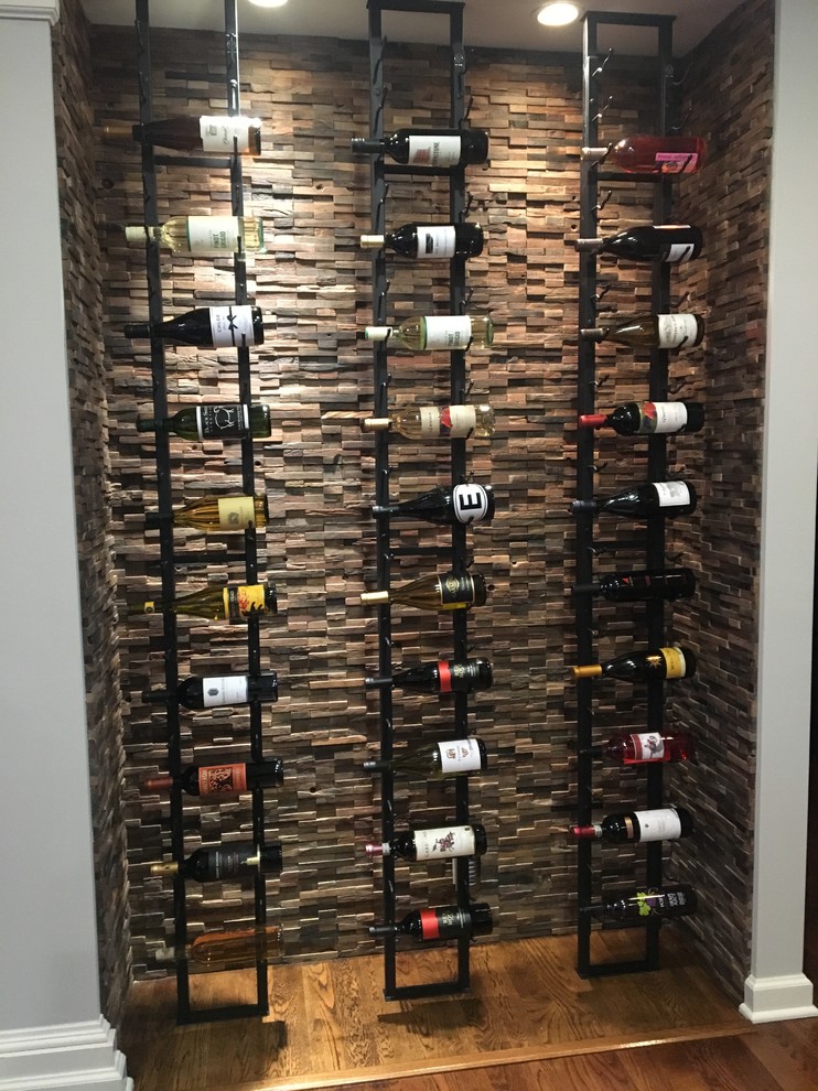 This is an example of a small contemporary wine cellar in New York with storage racks.