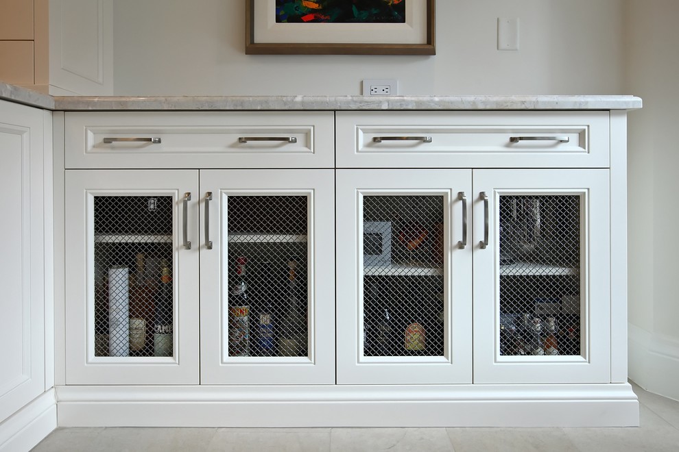 Enclosed kitchen - large transitional u-shaped limestone floor and beige floor enclosed kitchen idea in Toronto with an undermount sink, recessed-panel cabinets, white cabinets, granite countertops, beige backsplash, ceramic backsplash, paneled appliances and a peninsula